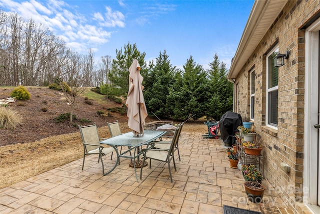 view of patio featuring outdoor dining space, visible vents, and a grill