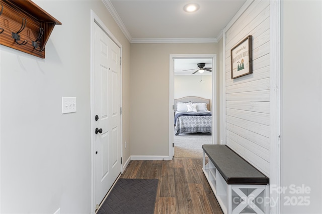 mudroom with ornamental molding, dark wood-style flooring, and baseboards