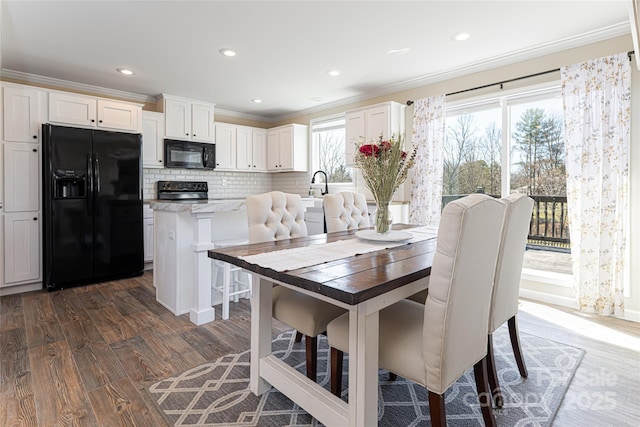 dining room with ornamental molding, recessed lighting, and dark wood-style floors