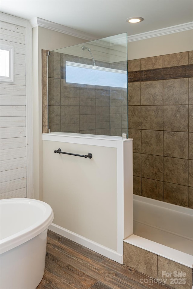 full bath featuring ornamental molding, wood finished floors, a freestanding tub, and walk in shower