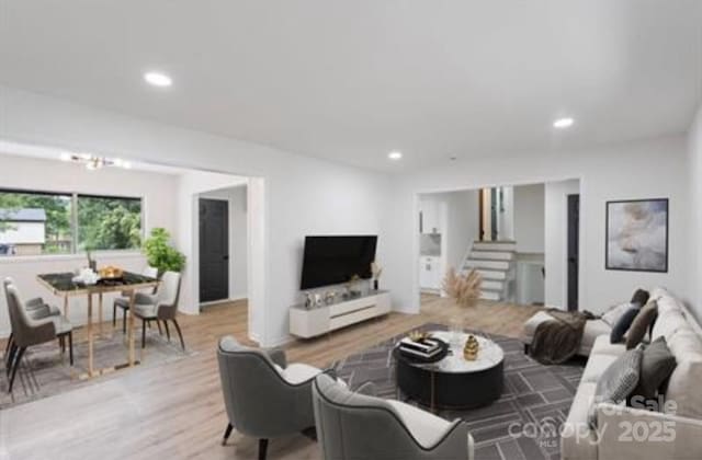 living area with stairway, wood finished floors, and recessed lighting