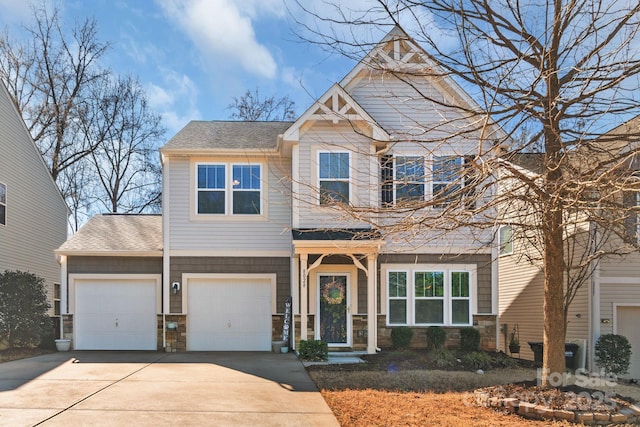 craftsman house with stone siding, roof with shingles, and concrete driveway