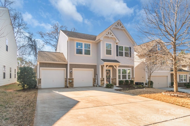 craftsman house with stone siding, concrete driveway, and roof with shingles