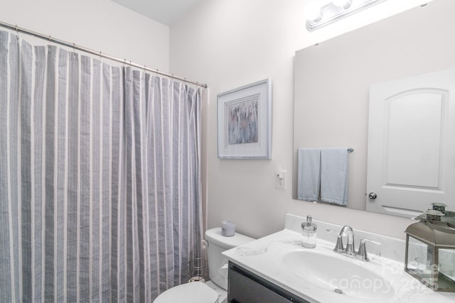 full bath featuring curtained shower, vanity, and toilet