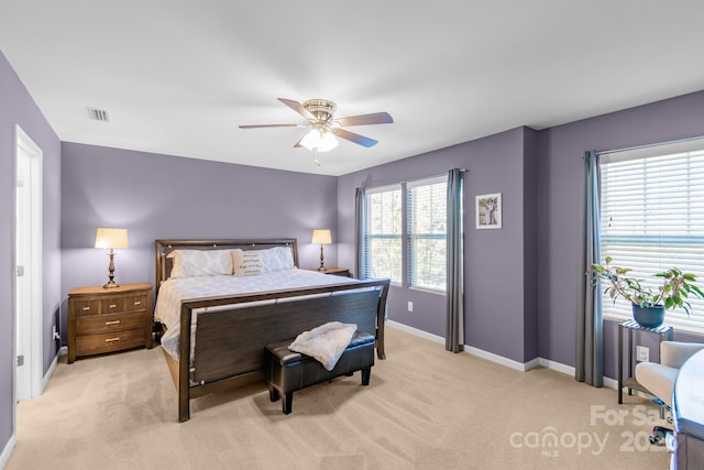 bedroom featuring baseboards, a ceiling fan, visible vents, and light colored carpet