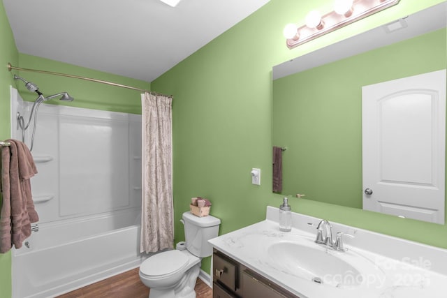 full bath featuring shower / tub combo, vanity, toilet, and wood finished floors