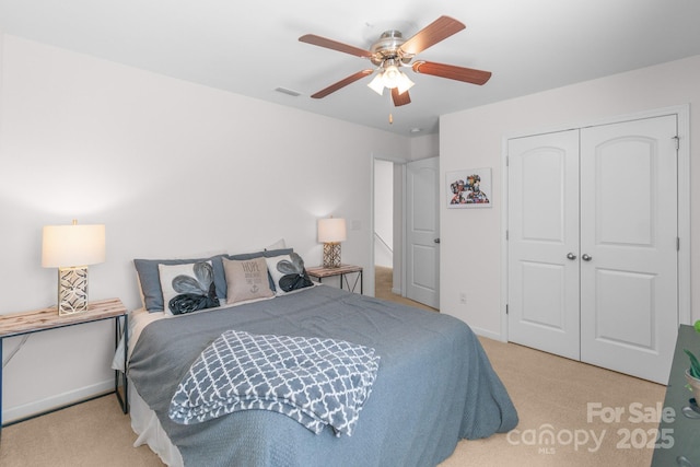 bedroom featuring baseboards, visible vents, a ceiling fan, carpet flooring, and a closet