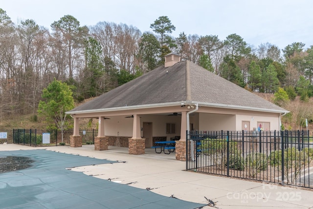 view of community featuring a patio, a swimming pool, and fence