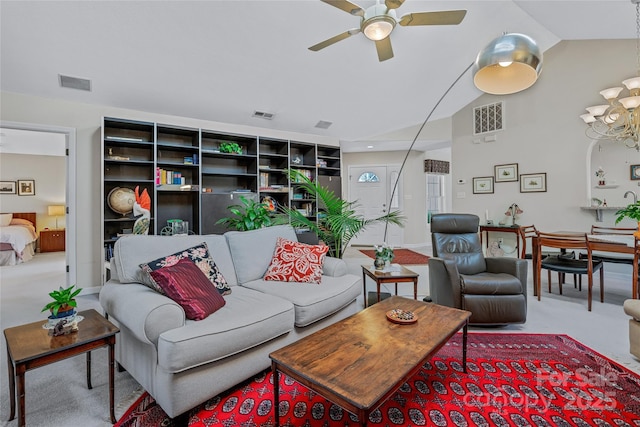 living area with lofted ceiling, visible vents, carpet flooring, and ceiling fan with notable chandelier