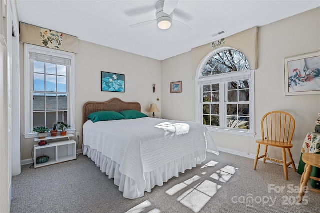 carpeted bedroom featuring visible vents, ceiling fan, and baseboards