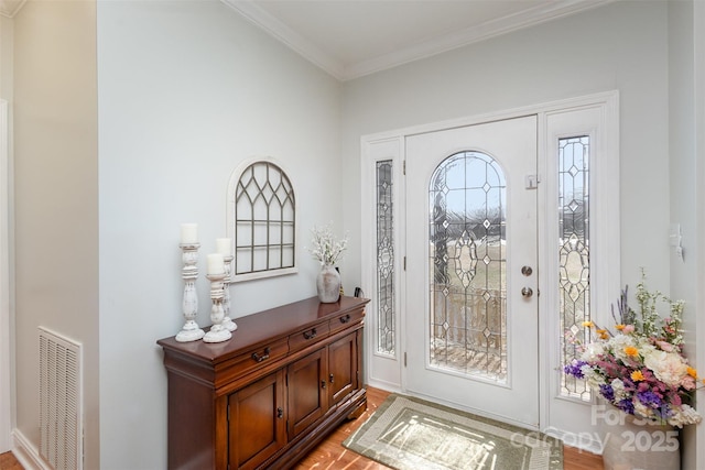 entryway featuring light wood-style floors, visible vents, and crown molding