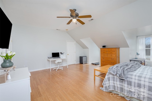 bedroom featuring visible vents, light wood-style flooring, vaulted ceiling, ceiling fan, and baseboards