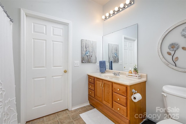 bathroom featuring toilet and vanity