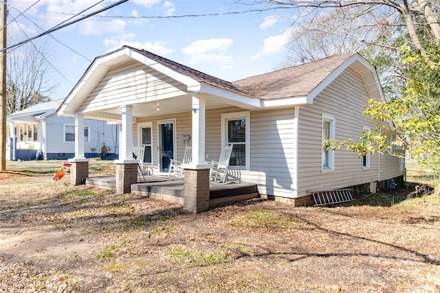 view of front of property featuring covered porch and roof with shingles