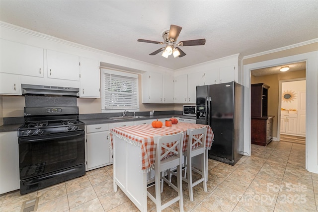 kitchen featuring a sink, a kitchen island, white cabinetry, black appliances, and dark countertops