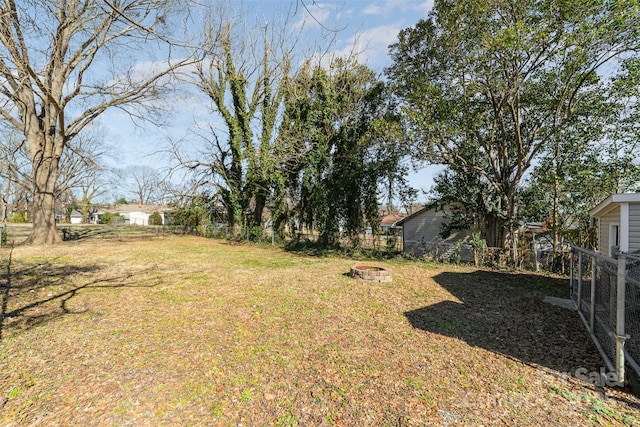 view of yard featuring a fire pit and fence