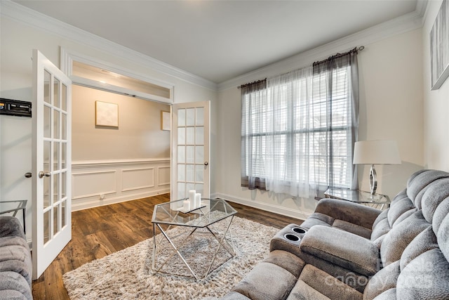 living room featuring a healthy amount of sunlight, ornamental molding, dark wood finished floors, and french doors