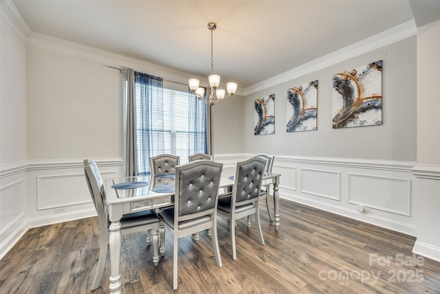 dining space with ornamental molding, dark wood finished floors, and an inviting chandelier