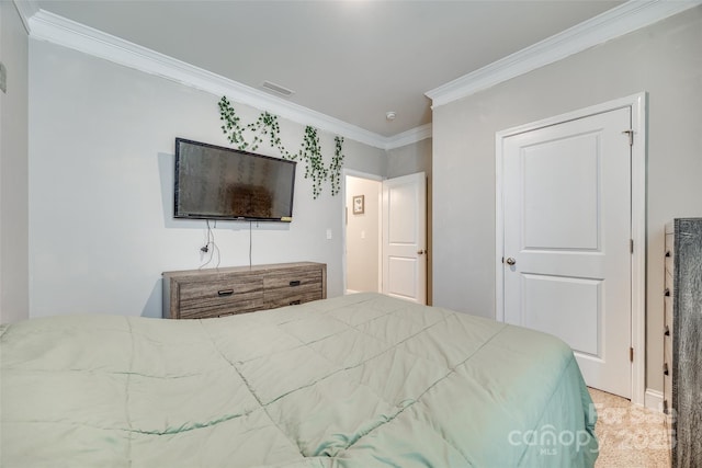 carpeted bedroom featuring visible vents and crown molding