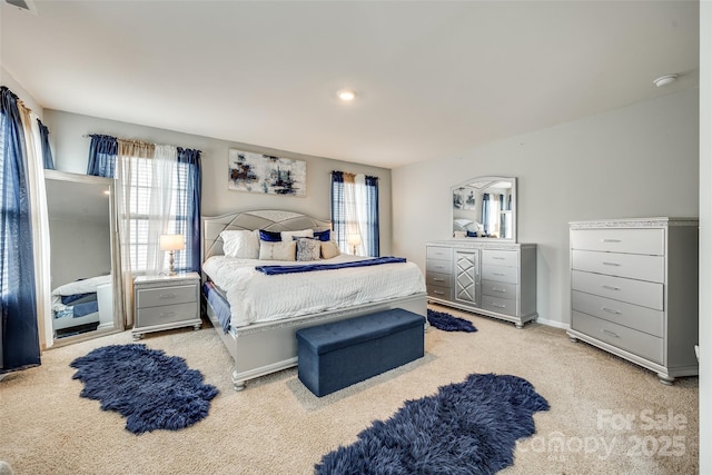 bedroom with baseboards and light colored carpet