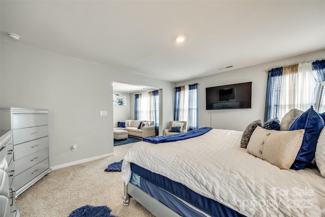 bedroom featuring light carpet, visible vents, and baseboards