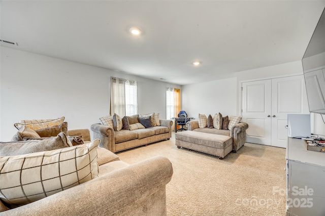 living area featuring light carpet, visible vents, and recessed lighting