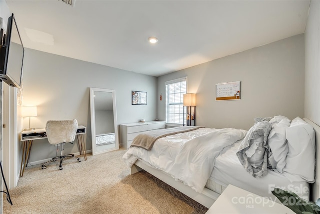 bedroom featuring light colored carpet and baseboards