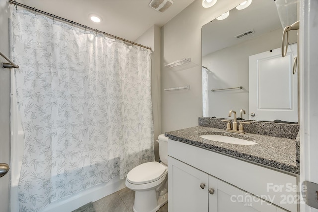 bathroom with visible vents, vanity, toilet, and tile patterned floors