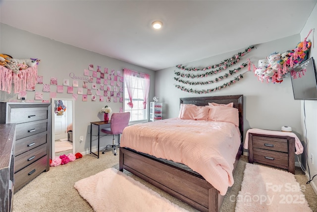 bedroom featuring light colored carpet and baseboards