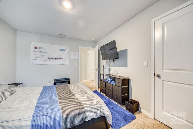 bedroom with light carpet, visible vents, and baseboards