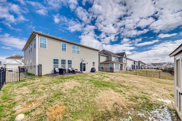 rear view of property featuring a residential view, a patio area, a fenced backyard, and a yard