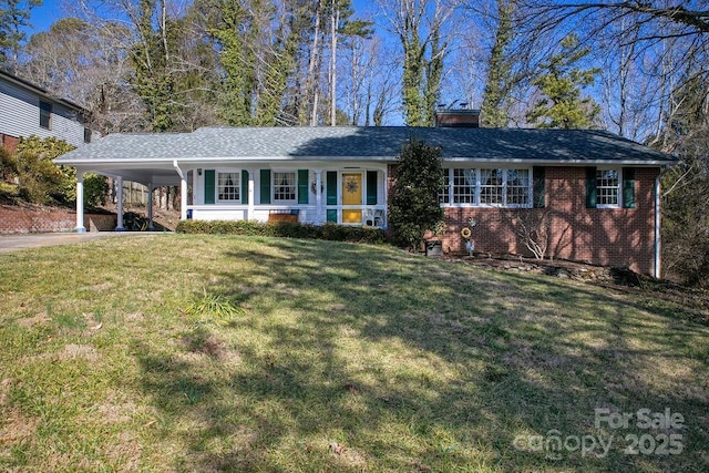 single story home with driveway, a chimney, an attached carport, a front yard, and brick siding