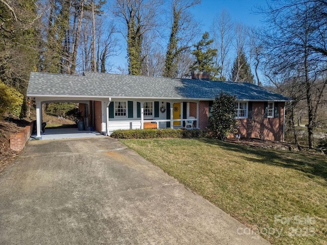 ranch-style house featuring driveway, a chimney, roof with shingles, a front lawn, and brick siding