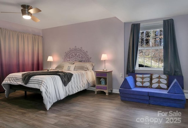 bedroom with a ceiling fan, baseboards, and wood finished floors