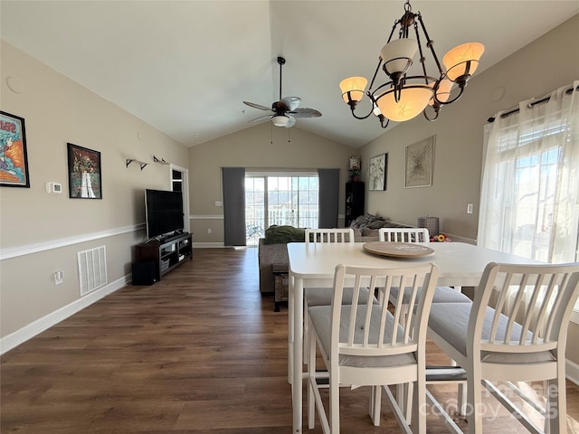 dining area with ceiling fan with notable chandelier, dark wood-style flooring, visible vents, baseboards, and vaulted ceiling