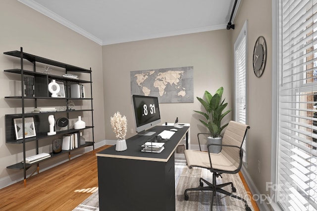 office area with crown molding, baseboards, and wood finished floors