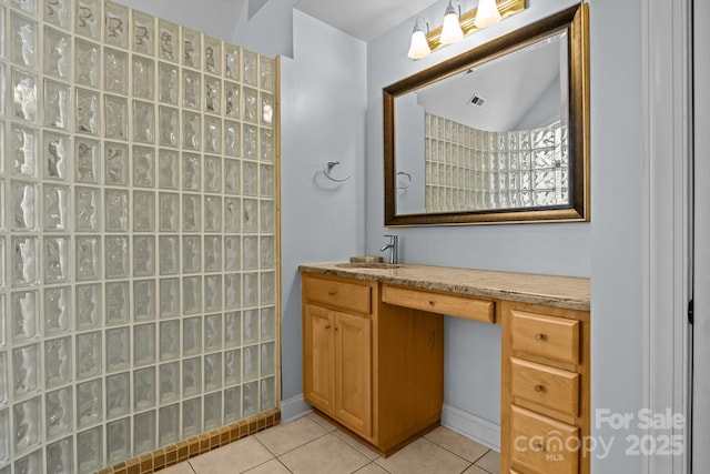 bathroom with tile patterned flooring and vanity