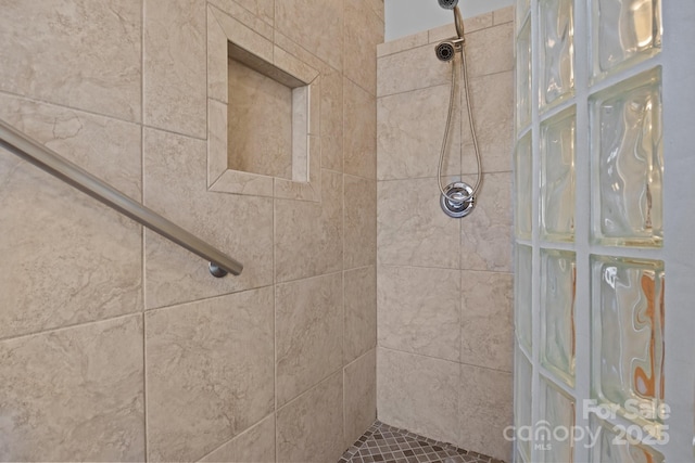 bathroom with a tile shower