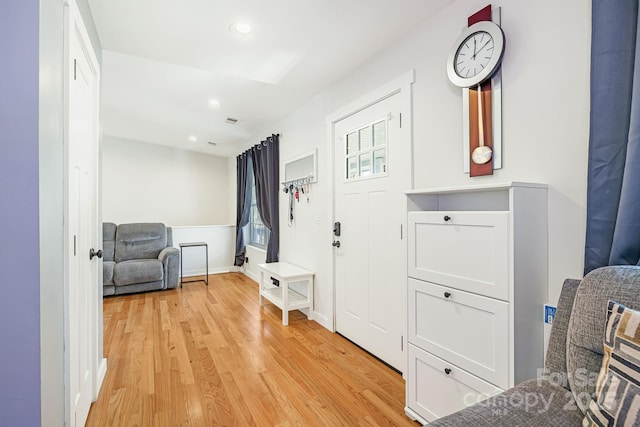 interior space featuring light wood-style flooring, visible vents, baseboards, and recessed lighting