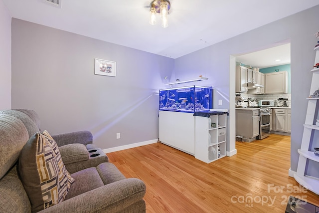 living area with light wood finished floors and baseboards