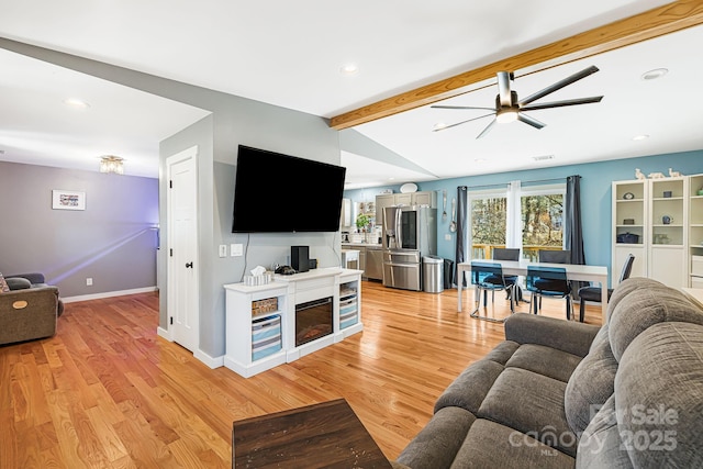 living room with recessed lighting, baseboards, vaulted ceiling with beams, and light wood finished floors