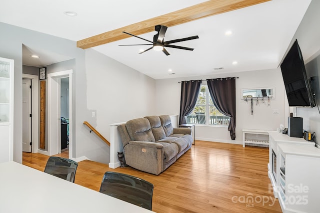 living area with recessed lighting, beamed ceiling, light wood-style flooring, and baseboards