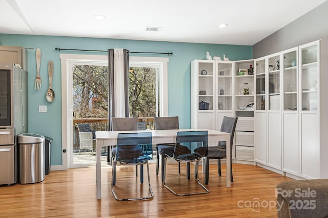 dining room featuring recessed lighting, visible vents, and light wood-style flooring