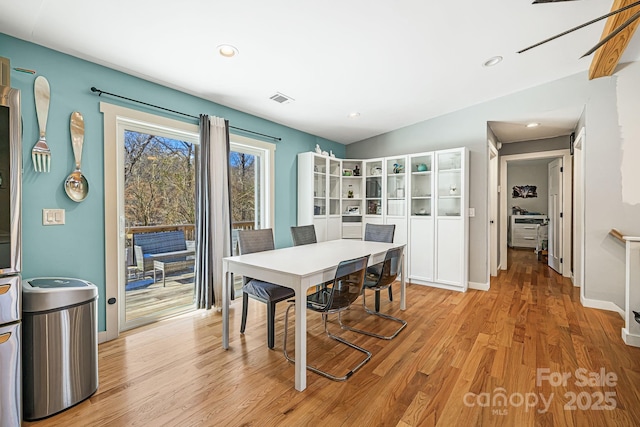 dining room featuring light wood finished floors, baseboards, visible vents, and recessed lighting