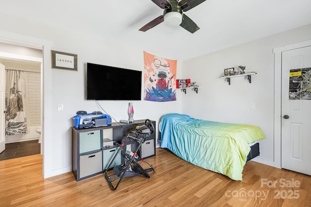 bedroom with a ceiling fan, baseboards, and wood finished floors