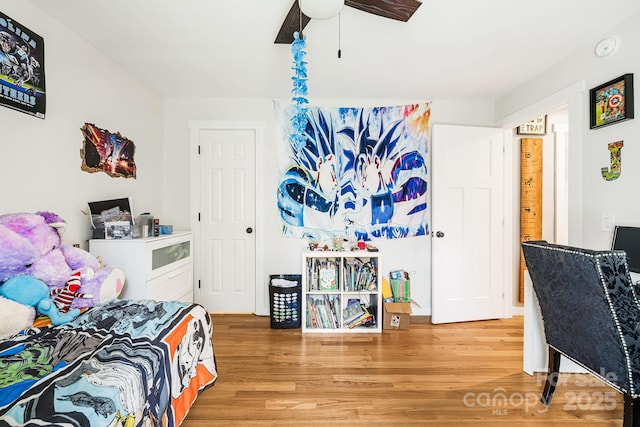 bedroom with a ceiling fan and wood finished floors