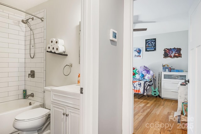 bathroom featuring  shower combination, vanity, toilet, and wood finished floors