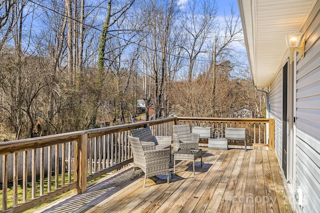 wooden terrace with an outdoor hangout area