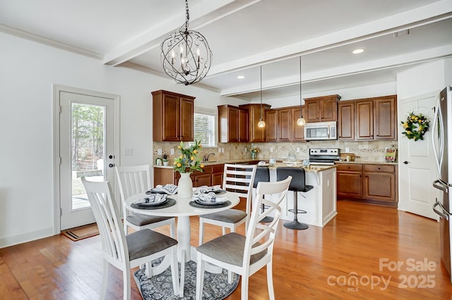 dining space with light wood finished floors, recessed lighting, ornamental molding, a chandelier, and beamed ceiling