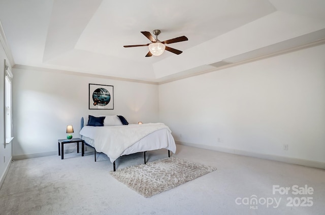 bedroom featuring visible vents, baseboards, ornamental molding, carpet, and a raised ceiling